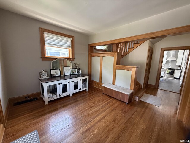 344 S 24th St, Quincy, IL 62301 - unfurnished living room with stairs, wood finished floors, and baseboards