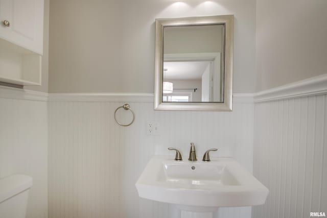 3705 Briarwood Dr, Quincy, IL 62301 - bathroom featuring a wainscoted wall, a sink, and toilet