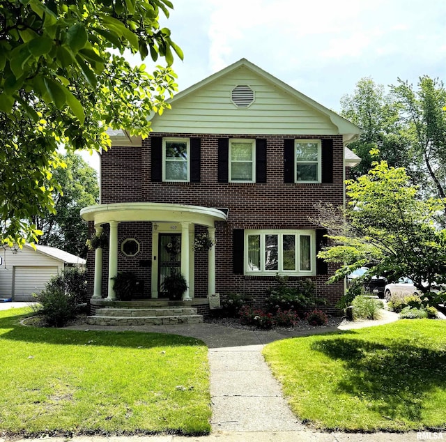409 N Broadway St, Havana, IL 62644 - view of front of home with a front yard, an outbuilding, and brick siding