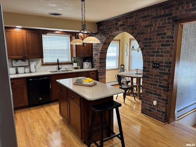 409 N Broadway St, Havana, IL 62644 - kitchen featuring dishwasher, a sink, baseboard heating, and light wood-style flooring
