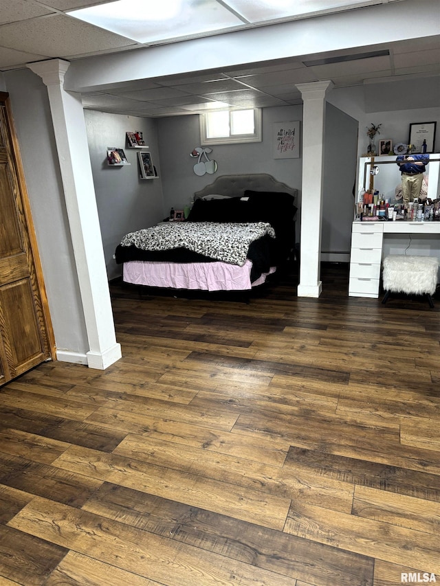 409 N Broadway St, Havana, IL 62644 - bedroom with wood finished floors, baseboards, and a paneled ceiling