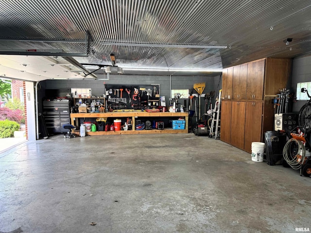 409 N Broadway St, Havana, IL 62644 - garage featuring a workshop area, a garage door opener, and concrete block wall