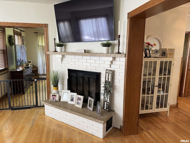 409 N Broadway St, Havana, IL 62644 - living area featuring wood finished floors and a fireplace