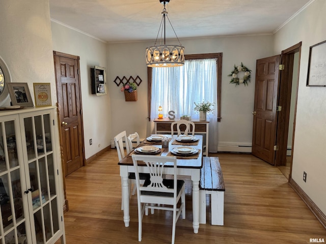 409 N Broadway St, Havana, IL 62644 - dining room with a chandelier, wood finished floors, baseboard heating, baseboards, and crown molding