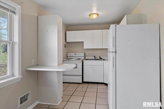 2309 W Lawrence Ave, Springfield, IL 62704 - kitchen featuring white appliances, white cabinetry, light tile patterned flooring, light countertops, and tasteful backsplash