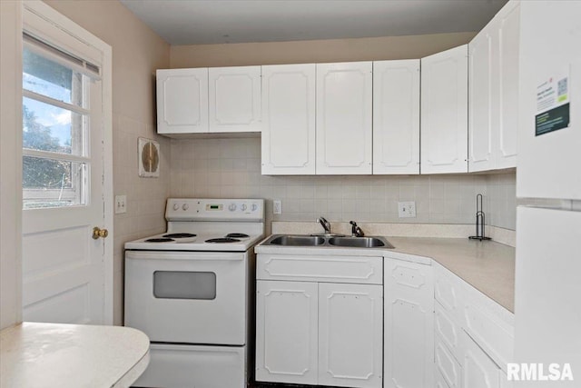 2309 W Lawrence Ave, Springfield, IL 62704 - kitchen with white appliances, a sink, white cabinets, tasteful backsplash, and light countertops