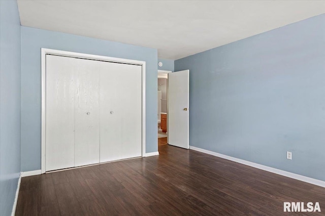 2309 W Lawrence Ave, Springfield, IL 62704 - unfurnished bedroom featuring wood finished floors, a closet, and baseboards