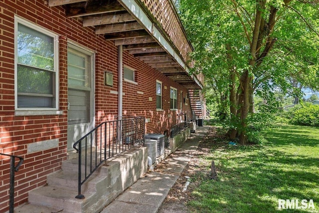 2309 W Lawrence Ave, Springfield, IL 62704 - view of property exterior with brick siding, a lawn, and central AC unit
