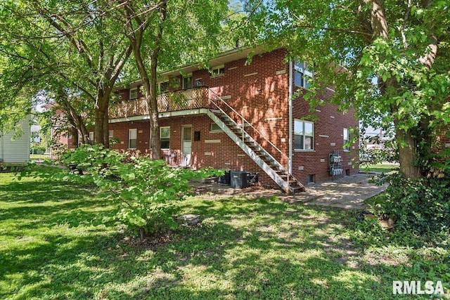 2309 W Lawrence Ave, Springfield, IL 62704 - back of property featuring brick siding, a yard, central AC, stairs, and a patio area