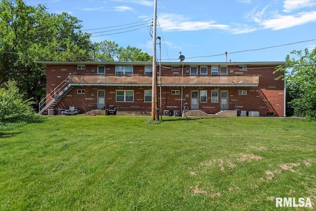 2309 W Lawrence Ave, Springfield, IL 62704 - back of property featuring stairway, a yard, and brick siding