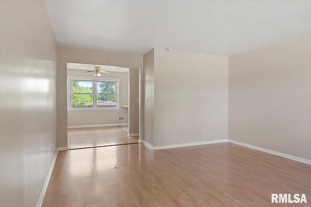 2309 W Lawrence Ave, Springfield, IL 62704 - unfurnished room featuring wood finished floors, baseboards, and ceiling fan