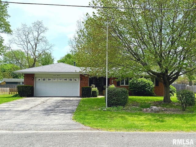 1352 N Lawrence Ave, Taylorville, IL 62568 - view of front facade with asphalt driveway, brick siding, and a garage