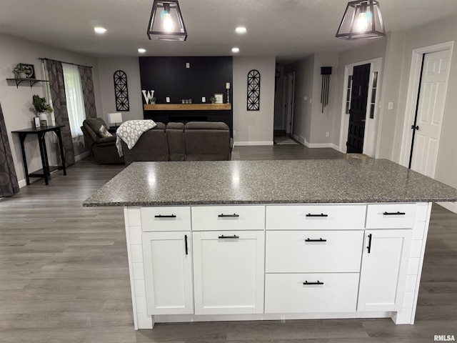 1352 N Lawrence Ave, Taylorville, IL 62568 - kitchen featuring baseboards, dark stone counters, open floor plan, wood finished floors, and recessed lighting
