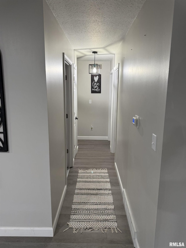 1352 N Lawrence Ave, Taylorville, IL 62568 - hallway with dark wood finished floors, baseboards, and a textured ceiling
