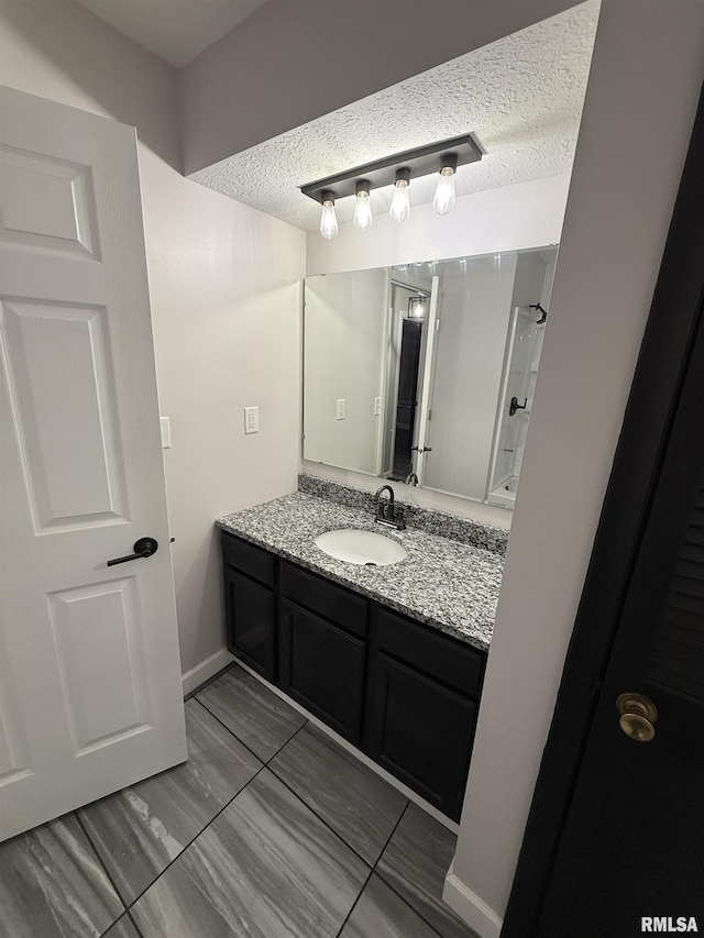 1352 N Lawrence Ave, Taylorville, IL 62568 - bathroom with vanity and a textured ceiling