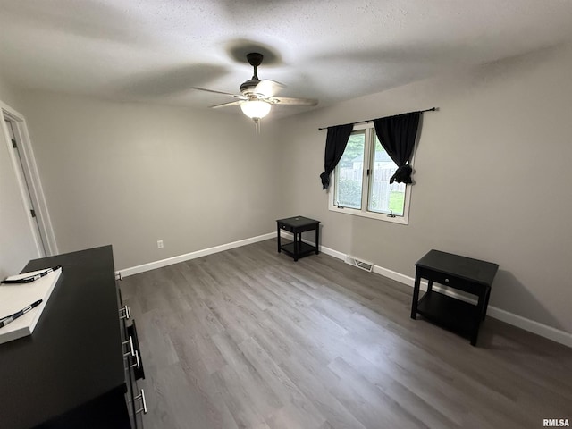 1352 N Lawrence Ave, Taylorville, IL 62568 - misc room with a ceiling fan, dark wood-style flooring, and baseboards