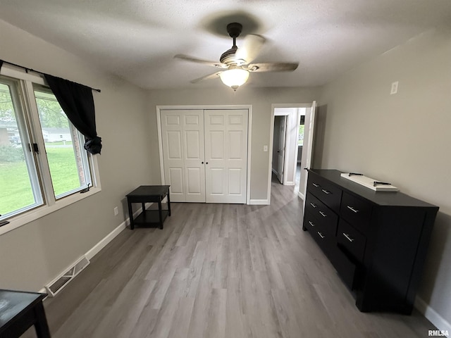 1352 N Lawrence Ave, Taylorville, IL 62568 - bedroom with multiple windows, light wood-style flooring, a closet, and baseboards