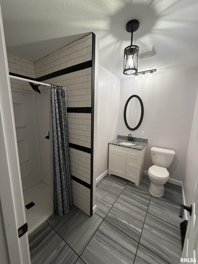 1352 N Lawrence Ave, Taylorville, IL 62568 - bathroom featuring a textured ceiling, a stall shower, toilet, vanity, and baseboards