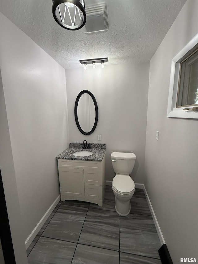 1352 N Lawrence Ave, Taylorville, IL 62568 - half bath with toilet, vanity, a textured ceiling, and baseboards