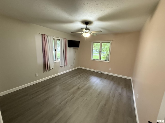 1352 N Lawrence Ave, Taylorville, IL 62568 - unfurnished room with ceiling fan, baseboards, and dark wood-style flooring