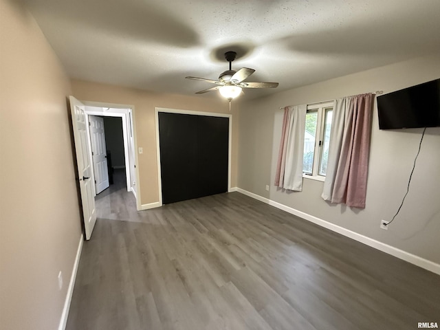 1352 N Lawrence Ave, Taylorville, IL 62568 - unfurnished bedroom with wood finished floors, baseboards, and ceiling fan