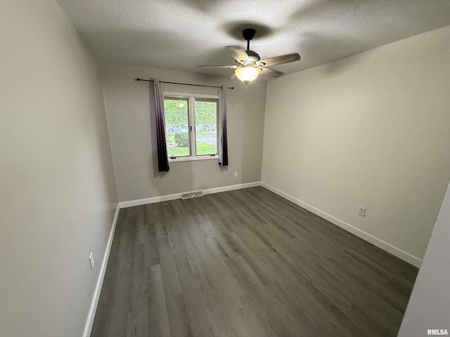 1352 N Lawrence Ave, Taylorville, IL 62568 - unfurnished room with a textured ceiling, ceiling fan, dark wood finished floors, and baseboards