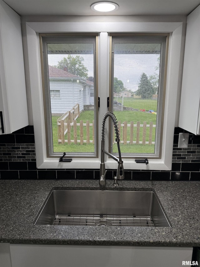 1352 N Lawrence Ave, Taylorville, IL 62568 - kitchen view of a sink, white cabinetry, and tasteful backsplash