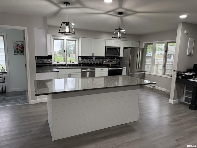 1352 N Lawrence Ave, Taylorville, IL 62568 - kitchen with stainless steel appliances, a sink, baseboards, white cabinets, and tasteful backsplash