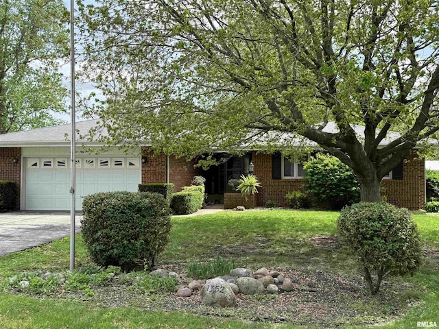 1352 N Lawrence Ave, Taylorville, IL 62568 - obstructed view of property featuring brick siding, an attached garage, driveway, and a front lawn