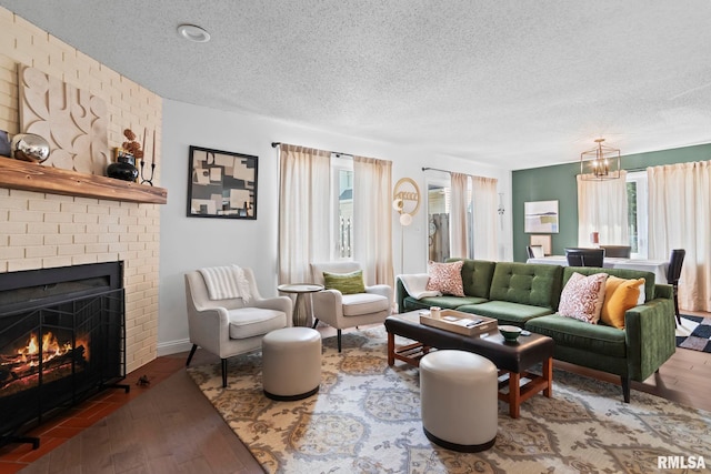 704 Rickard Rd, Springfield, IL 62704 - living room with plenty of natural light, a textured ceiling, a brick fireplace, a chandelier, and wood finished floors