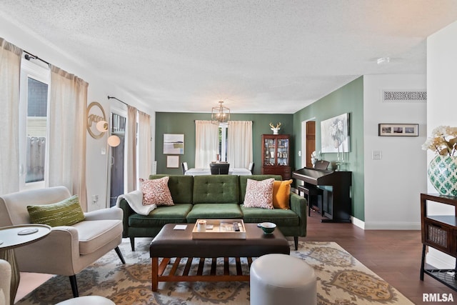 704 Rickard Rd, Springfield, IL 62704 - living area featuring a textured ceiling, baseboards, wood finished floors, and a chandelier