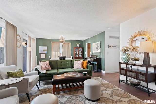 704 Rickard Rd, Springfield, IL 62704 - living area with a chandelier, a textured ceiling, wood finished floors, baseboards, and healthy amount of natural light