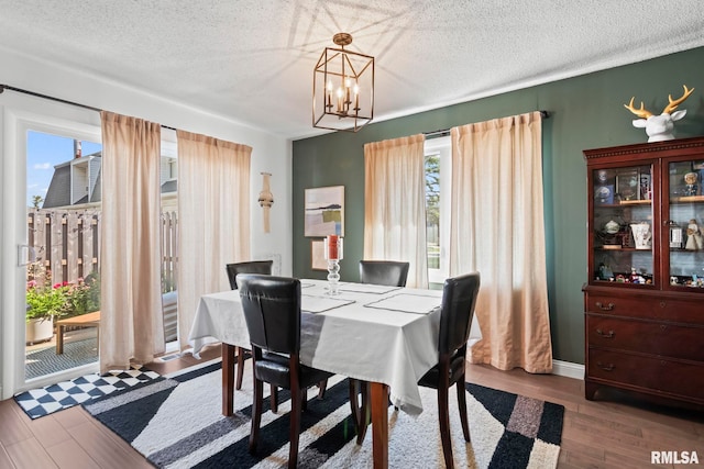 704 Rickard Rd, Springfield, IL 62704 - dining area featuring a chandelier, wood finished floors, and a textured ceiling