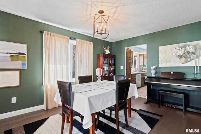 704 Rickard Rd, Springfield, IL 62704 - dining room with a chandelier, dark wood-type flooring, baseboards, and a textured ceiling