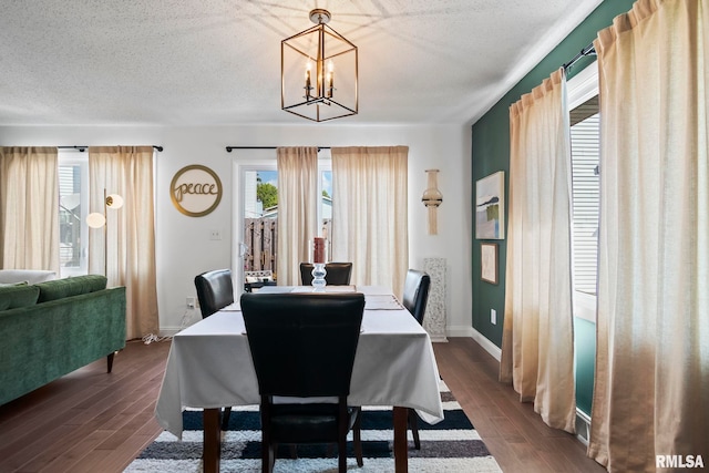 704 Rickard Rd, Springfield, IL 62704 - dining space featuring a chandelier, dark wood-style flooring, baseboards, and a textured ceiling