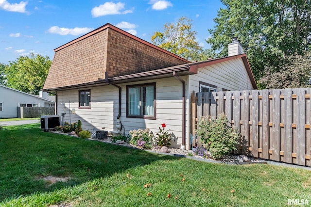 704 Rickard Rd, Springfield, IL 62704 - view of home's exterior with a chimney, central AC, and a shingled roof