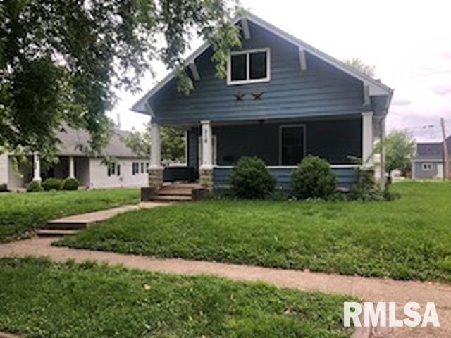 216 W Church St, Palmyra, MO 63461 - view of front of home featuring covered porch and a front yard
