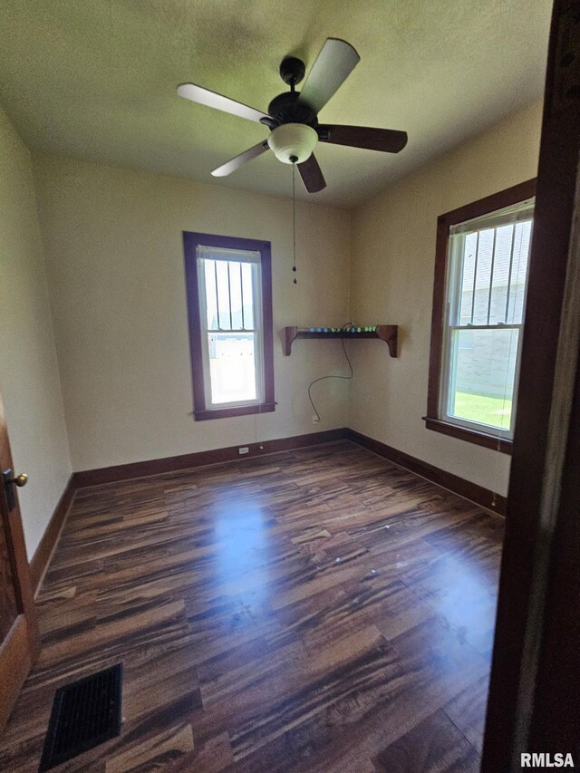 216 W Church St, Palmyra, MO 63461 - spare room featuring dark wood-style flooring and ceiling fan
