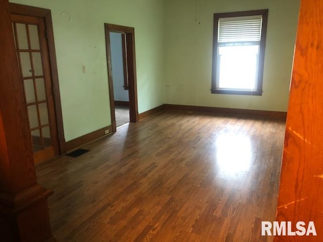 216 W Church St, Palmyra, MO 63461 - unfurnished room featuring wood finished floors and baseboards