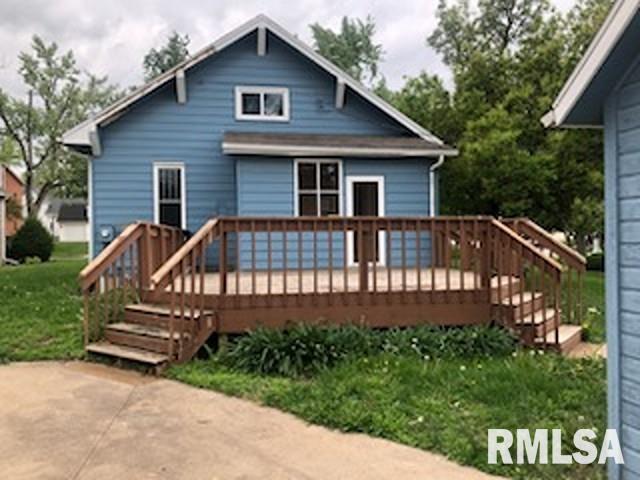 216 W Church St, Palmyra, MO 63461 - rear view of property featuring a deck and a lawn