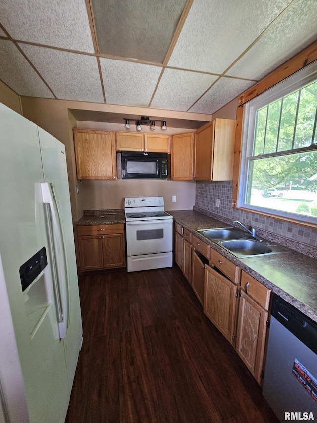 216 W Church St, Palmyra, MO 63461 - kitchen featuring white appliances, dark wood-type flooring, dark countertops, and a drop ceiling