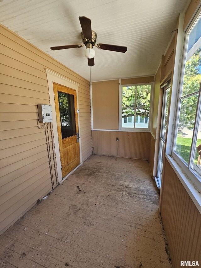 216 W Church St, Palmyra, MO 63461 - unfurnished sunroom featuring wooden walls, hardwood / wood-style floors, and ceiling fan