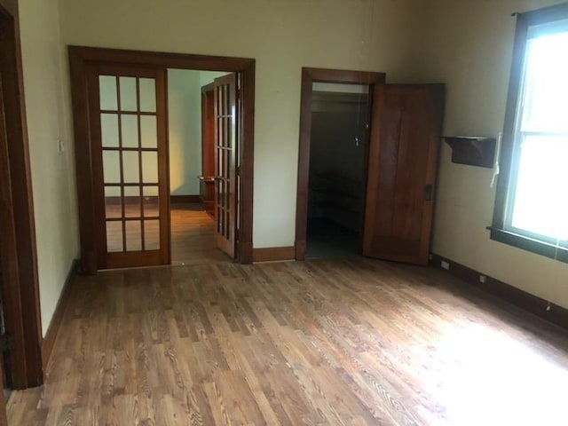 216 W Church St, Palmyra, MO 63461 - unfurnished room featuring wood finished floors and french doors