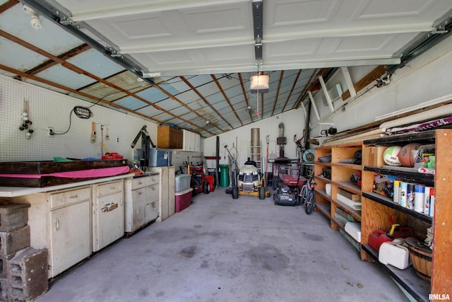 130 S State St, Mendon, IL 62351 - garage with a garage door opener and a workshop area
