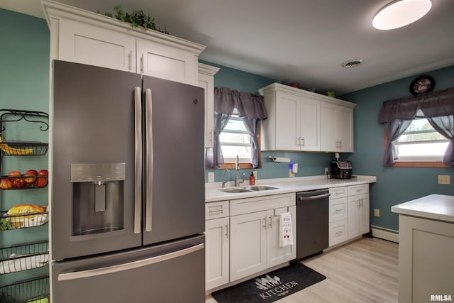 130 S State St, Mendon, IL 62351 - kitchen featuring stainless steel refrigerator with ice dispenser, dishwasher, a baseboard heating unit, a sink, and light countertops