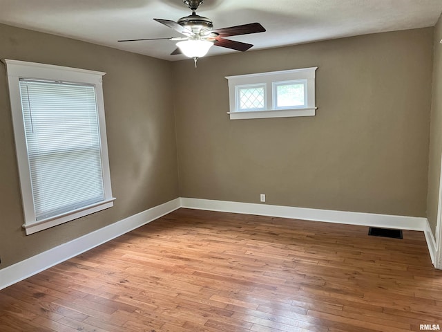 626 W Edwards St, Springfield, IL 62704 - empty room featuring wood-type flooring, ceiling fan, and baseboards