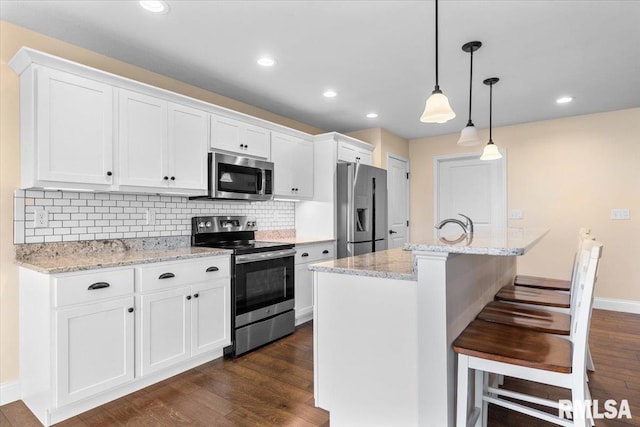 1809 Spartan Dr, Chatham, IL 62629 - kitchen with stainless steel appliances, white cabinets, tasteful backsplash, dark wood-style floors, and recessed lighting