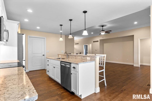 1809 Spartan Dr, Chatham, IL 62629 - kitchen featuring stainless steel appliances, a sink, a kitchen bar, white cabinetry, and recessed lighting