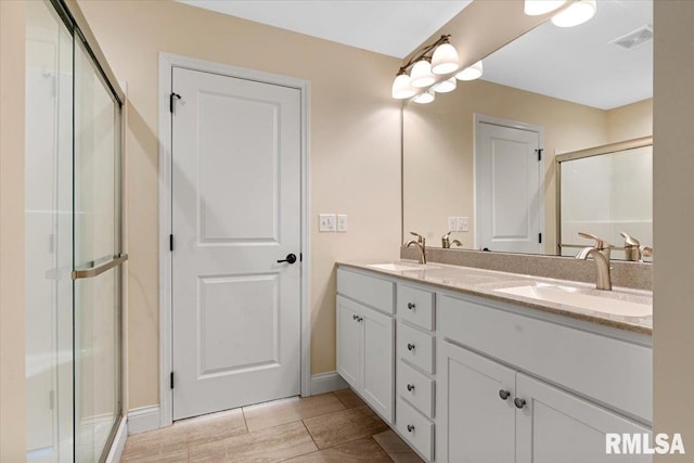 1809 Spartan Dr, Chatham, IL 62629 - full bathroom featuring double vanity, a shower stall, and baseboards