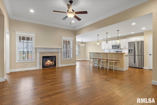 1809 Spartan Dr, Chatham, IL 62629 - living area with ceiling fan, dark wood-style flooring, baseboards, a tile fireplace, and ornamental molding